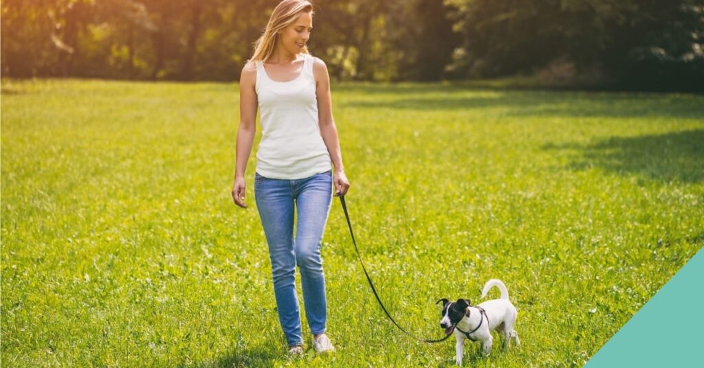Woman walking her dog on a lead